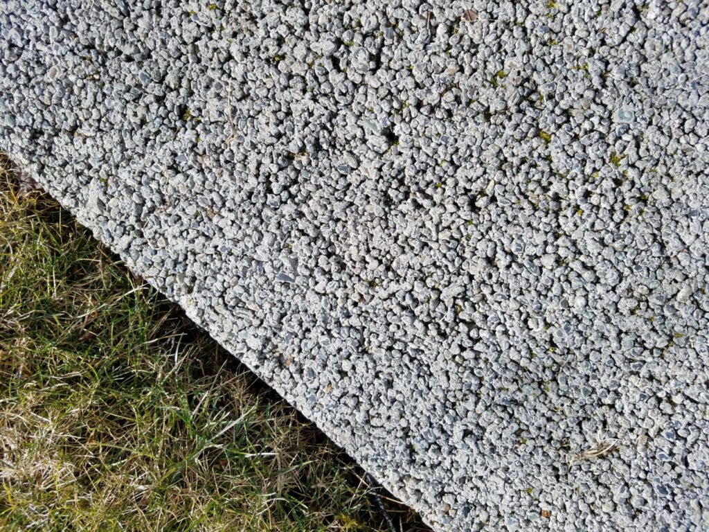 Pervious concrete has gaps tin the material that allow water to soak into the soil below. The sand and gravel below help remove pollutants. Pervious pavement needs cleaning to function properly.