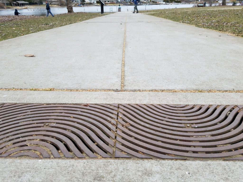 These decorative sidewalk filter drain grates extend the width of the sidewalk reducing pollution by allowing runoff to reach the media filter below the sidewalk.