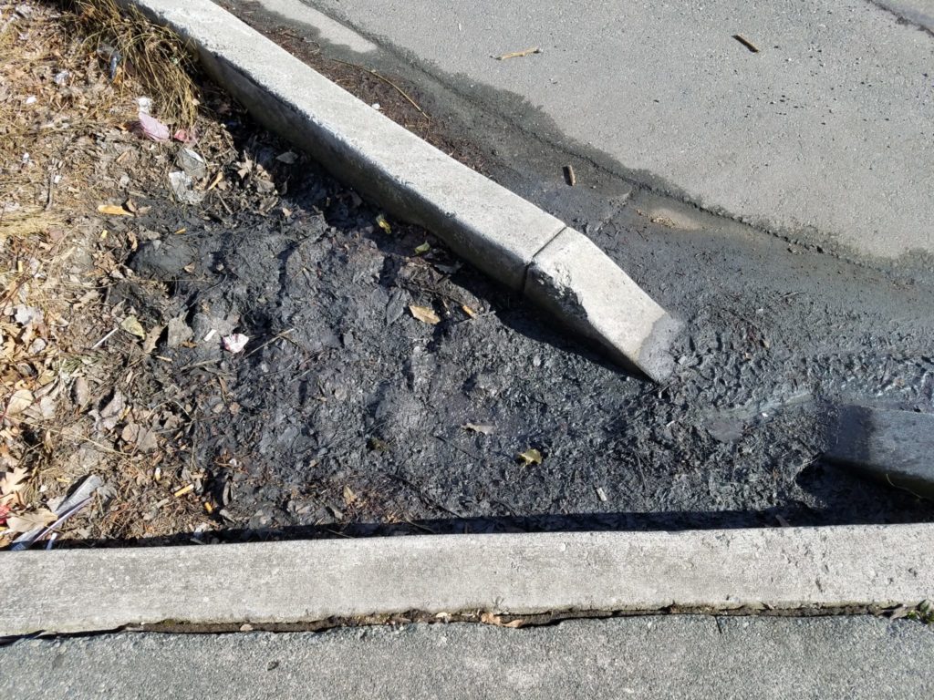 Sediment, grease, and oil from stormwater runoff settle out at the curb cut. This collected sediment is easily cleaned out by City maintenance crews.