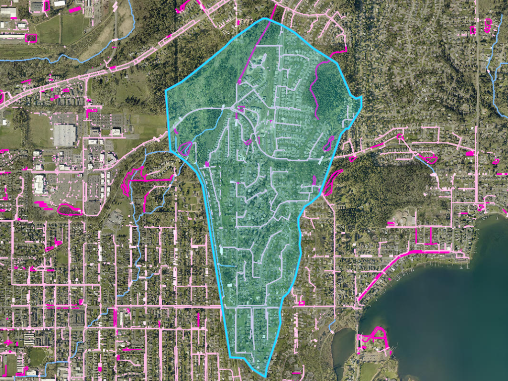 The green is the 400-acre drainage area for the St. Clair Pond. Magenta shapes are stormwater facilities and the pink lines represent stormwater pipes of the drainage system.