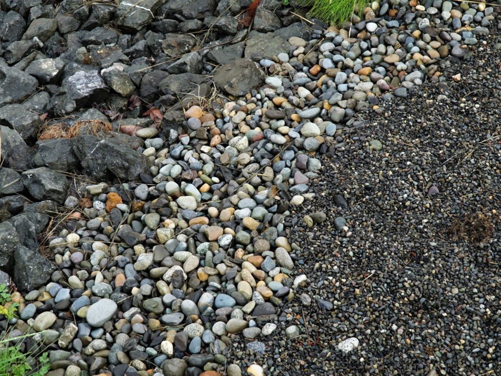 Rocks, cobbles, and gravel are arranged by size of material, so the runoff flows down through it.
